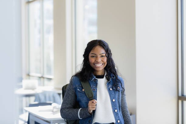 The beautiful young adult smiles for her headshot that will be in the school newspaper.